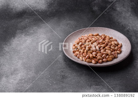 Salted pistachio nuts in shells as a healthy, high calorie food ingredient. Pistachio nuts 138089192
