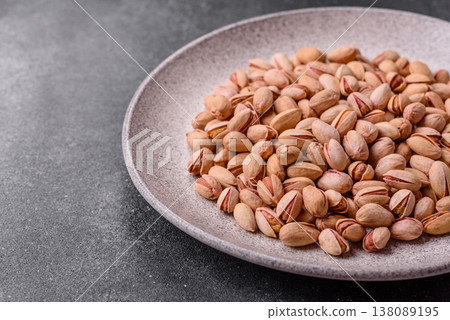 Salted pistachio nuts in shells as a healthy, high calorie food ingredient. Pistachio nuts 138089195