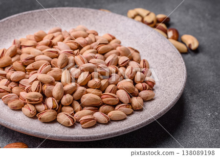 Salted pistachio nuts in shells as a healthy, high calorie food ingredient. Pistachio nuts 138089198