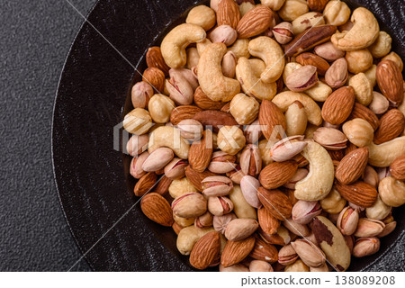 A mix of cashews, pistachios, almonds, macadamia and hazelnuts. Nuts as a food background A mix of cashews, pistachios, almonds, macadamia and hazelnuts. Nuts as a food background 138089208