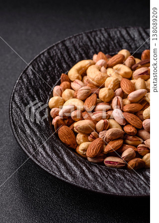 A mix of cashews, pistachios, almonds, macadamia and hazelnuts. Nuts as a food background A mix of cashews, pistachios, almonds, macadamia and hazelnuts. Nuts as a food background 138089209