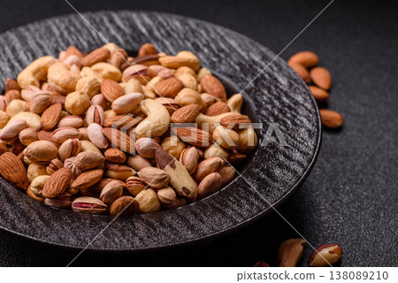 A mix of cashews, pistachios, almonds, macadamia and hazelnuts. Nuts as a food background A mix of cashews, pistachios, almonds, macadamia and hazelnuts. Nuts as a food background 138089210