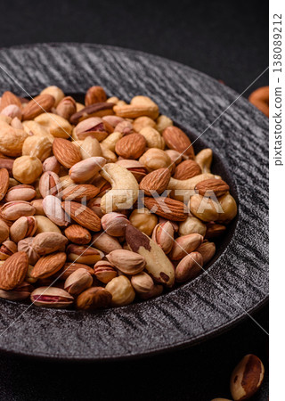 A mix of cashews, pistachios, almonds, macadamia and hazelnuts. Nuts as a food background A mix of cashews, pistachios, almonds, macadamia and hazelnuts. Nuts as a food background 138089212