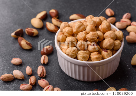 Whole peeled hazelnuts, roasted or raw, as an ingredient for healthy food. Hazelnuts as a background 138089260
