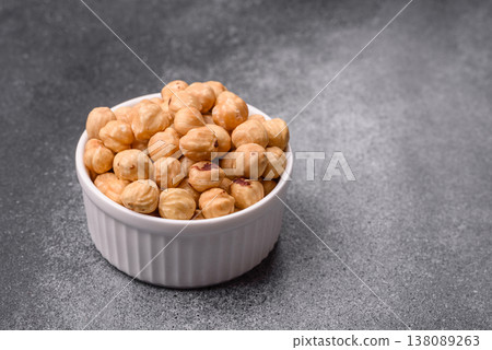 Whole peeled hazelnuts, roasted or raw, as an ingredient for healthy food. Hazelnuts as a background 138089263