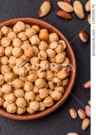 Whole peeled hazelnuts, roasted or raw, as an ingredient for healthy food. Hazelnuts as a background 138089276