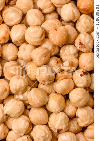 Whole peeled hazelnuts, roasted or raw, as an ingredient for healthy food. Hazelnuts as a background 138089281