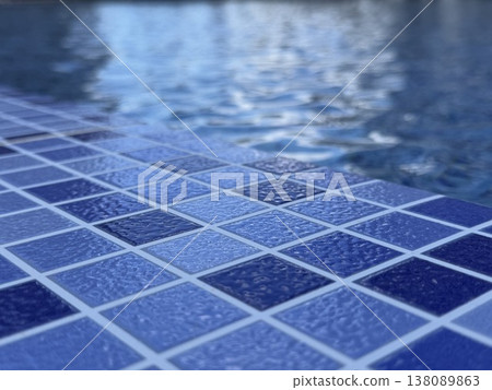 Blue ceramic pool tiles with rippling water on background reflecting light at swimming area 138089863