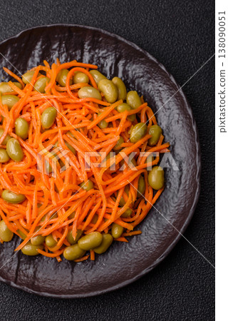 Asian salad with edamame beans, carrots, tofu, and spices. Edamame and carrot salad Asian salad with edamame beans, carrots, tofu, and spices. Edamame and carrot salad 138090051