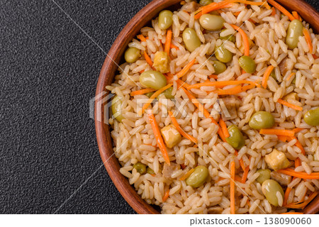 Asian food with rice, edamame, carrots, tofu, and spices. Rice with edamame and carrots 138090060