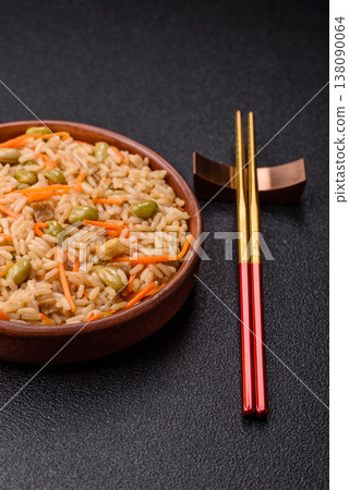 Asian food with rice, edamame, carrots, tofu, and spices. Rice with edamame and carrots Asian food with rice, edamame, carrots, tofu, and spices. Rice with edamame and carrots 138090064