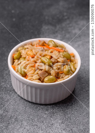 Asian food with rice, edamame, carrots, tofu, and spices. Rice with edamame and carrots Asian food with rice, edamame, carrots, tofu, and spices. Rice with edamame and carrots 138090076