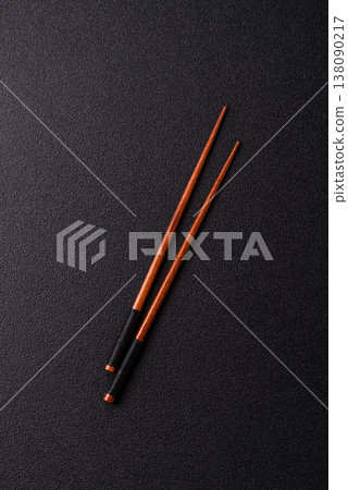 Wooden bamboo chopsticks for sushi and other Asian food with a blank background. Wooden chopsticks Wooden bamboo chopsticks for sushi and other Asian food with a blank background. Wooden chopsticks 138090217
