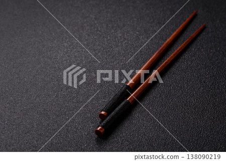 Wooden bamboo chopsticks for sushi and other Asian food with a blank background. Wooden chopsticks Wooden bamboo chopsticks for sushi and other Asian food with a blank background. Wooden chopsticks 138090219