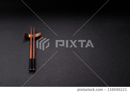 Wooden bamboo chopsticks for sushi and other Asian food with a blank background. Wooden chopsticks Wooden bamboo chopsticks for sushi and other Asian food with a blank background. Wooden chopsticks 138090221