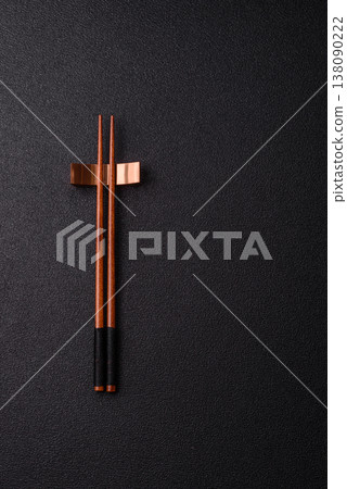 Wooden bamboo chopsticks for sushi and other Asian food with a blank background. Wooden chopsticks Wooden bamboo chopsticks for sushi and other Asian food with a blank background. Wooden chopsticks 138090222