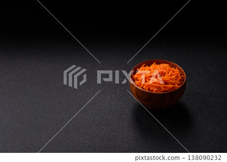 Spicy Korean carrot salad, grated with salt and spices, an Asian dish. Korean carrots Spicy Korean carrot salad, grated with salt and spices, an Asian dish. Korean carrots 138090232