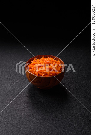 Spicy Korean carrot salad, grated with salt and spices, an Asian dish. Korean carrots Spicy Korean carrot salad, grated with salt and spices, an Asian dish. Korean carrots 138090234