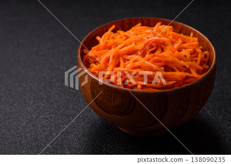 Spicy Korean carrot salad, grated with salt and spices, an Asian dish. Korean carrots Spicy Korean carrot salad, grated with salt and spices, an Asian dish. Korean carrots 138090235