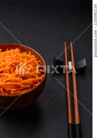 Spicy Korean carrot salad, grated with salt and spices, an Asian dish. Korean carrots Spicy Korean carrot salad, grated with salt and spices, an Asian dish. Korean carrots 138090239