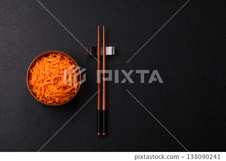 Spicy Korean carrot salad, grated with salt and spices, an Asian dish. Korean carrots Spicy Korean carrot salad, grated with salt and spices, an Asian dish. Korean carrots 138090241