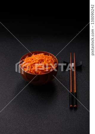 Spicy Korean carrot salad, grated with salt and spices, an Asian dish. Korean carrots Spicy Korean carrot salad, grated with salt and spices, an Asian dish. Korean carrots 138090242