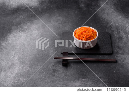Spicy Korean carrot salad, grated with salt and spices, an Asian dish. Korean carrots Spicy Korean carrot salad, grated with salt and spices, an Asian dish. Korean carrots 138090243