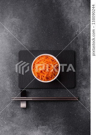 Spicy Korean carrot salad, grated with salt and spices, an Asian dish. Korean carrots Spicy Korean carrot salad, grated with salt and spices, an Asian dish. Korean carrots 138090244