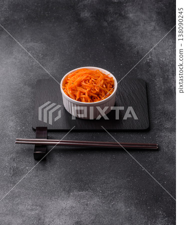 Spicy Korean carrot salad, grated with salt and spices, an Asian dish. Korean carrots 138090245