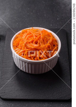Spicy Korean carrot salad, grated with salt and spices, an Asian dish. Korean carrots Spicy Korean carrot salad, grated with salt and spices, an Asian dish. Korean carrots 138090248