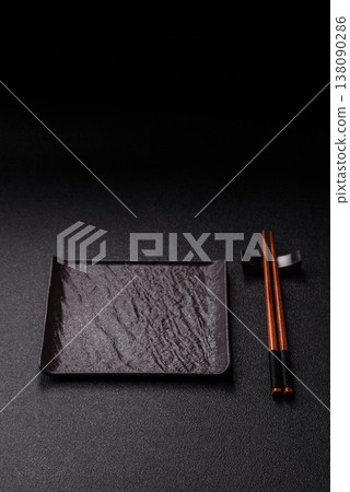 An empty ceramic square black plate with chopsticks for Asian food. An empty square plate 138090286