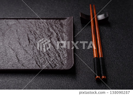 An empty ceramic square black plate with chopsticks for Asian food. An empty square plate 138090287