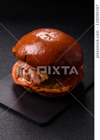 A burger with a patty, cheese, vegetables, and sauce. A burger with meat A burger with a patty, cheese, vegetables, and sauce. A burger with meat 138090387