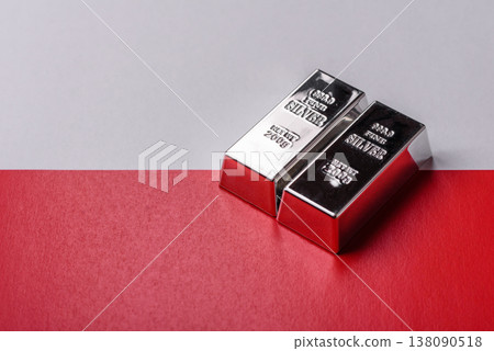 A silver bar, white metal against a backdrop of Polish flag, as a concept. A silver bar 138090518