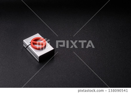 A metal cigarette box with a no smoking sign depicts a harmful habit. A cigarette box A metal cigarette box with a no smoking sign depicts a harmful habit. A cigarette box 138090541