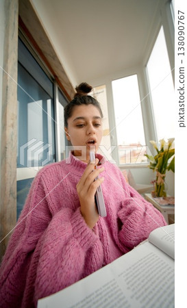 Woman Provides Informative Demonstration Of Her Device Using Gentle Lighting And Authentic Style Woman Provides Informative Demonstration Of Her Device Using Gentle Lighting And Authentic Style 138090767