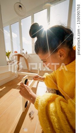 Woman Carefully Fitting Dowel. Sunlit Scene With Detailed Hardware And Meticulous Craftsmanship 138090768