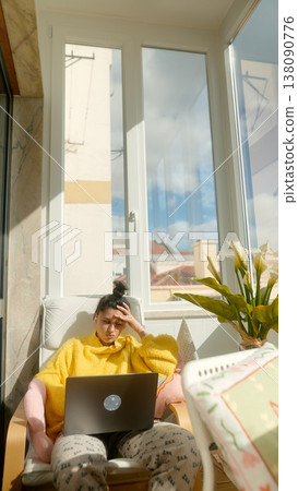 Young Woman In Cheerful Environment. Woman In Vibrant Hoodie Working Comfortably In City Apartment Young Woman In Cheerful Environment. Woman In Vibrant Hoodie Working Comfortably In City Apartment 138090776