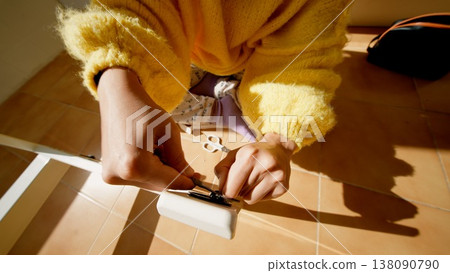Hands Tighten Hinge. Detailed View Of Hands Adjusting Door Hinge Using Screwdriver Under Warm Light 138090790