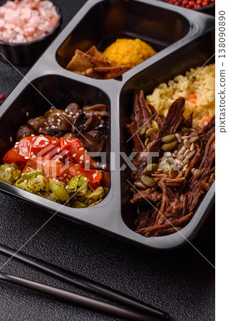 A bowl with beef, porridge, mushrooms, vegetables, sauce, and spices. Beef bowl 138090890