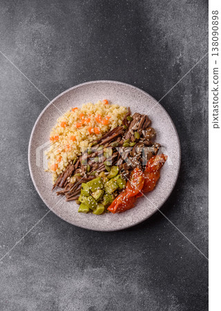 A bowl with beef, porridge, mushrooms, vegetables, sauce, and spices. Beef bowl A bowl with beef, porridge, mushrooms, vegetables, sauce, and spices. Beef bowl 138090898