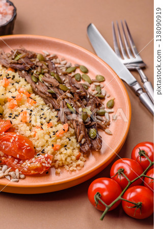 A bowl with beef, porridge, mushrooms, vegetables, sauce, and spices. Beef bowl 138090919