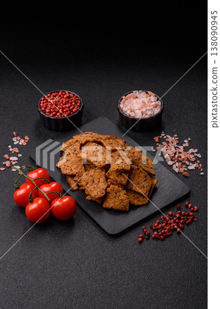 Croutons or crackers made from rye bread with garlic, salt, and spices. Croutons with salt 138090945