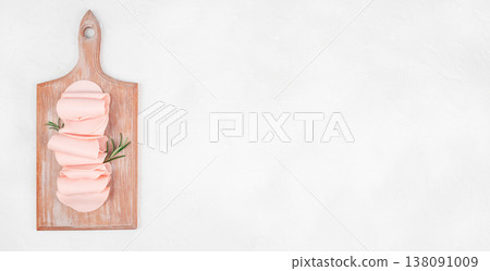 Ham slices on wooden cutting board over white background, top view food composition with copy space Ham slices on wooden cutting board over white background, top view food composition with copy space 138091009