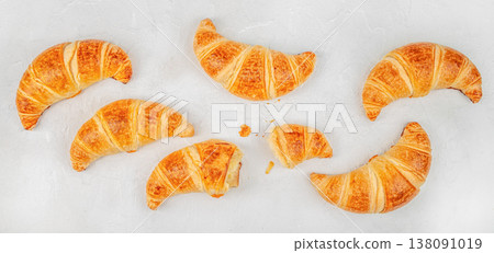 Croissants collection with bitten croissant on white background, top view bakery assortment Croissants collection with bitten croissant on white background, top view bakery assortment 138091019