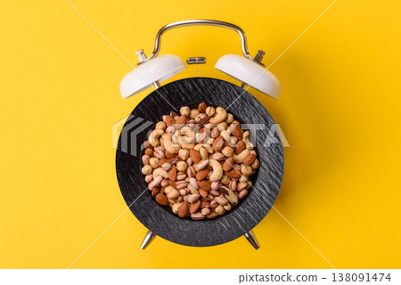A mix of cashews, pistachios, almonds, brazil nuts, and hazelnuts. Nuts as a food background A mix of cashews, pistachios, almonds, brazil nuts, and hazelnuts. Nuts as a food background 138091474