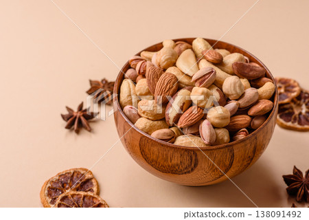 A mix of cashews, pistachios, almonds, brazil nuts and hazelnuts. Nuts as a food background A mix of cashews, pistachios, almonds, brazil nuts and hazelnuts. Nuts as a food background 138091492