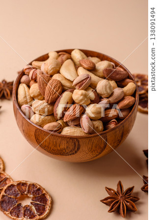 A mix of cashews, pistachios, almonds, brazil nuts and hazelnuts. Nuts as a food background A mix of cashews, pistachios, almonds, brazil nuts and hazelnuts. Nuts as a food background 138091494