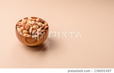 A mix of cashews, pistachios, almonds, brazil nuts and hazelnuts. Nuts as a food background A mix of cashews, pistachios, almonds, brazil nuts and hazelnuts. Nuts as a food background 138091497