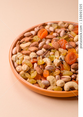 A mix of nuts and dried fruits as ingredients for a healthy meal. Nuts and dried fruits A mix of nuts and dried fruits as ingredients for a healthy meal. Nuts and dried fruits 138091505